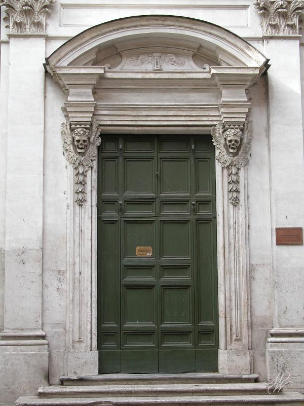 DSCN3955.JPG - Santa Maria dell'Orazione e Morte (St Mary of Prayer and Death) on Via Giulia, Rome. Ferdinando Fuga's 1738 broque façade has many references to death including the winged skulls and the clepsydra (hourglass) above the door. The church belonged to a confraternity that gave 'proper' burials to the poor.